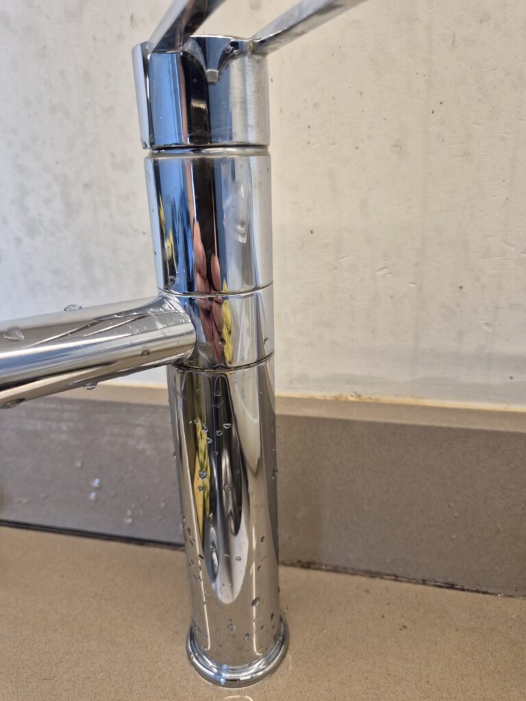 Polished chrome kitchen tap after professional cleaning