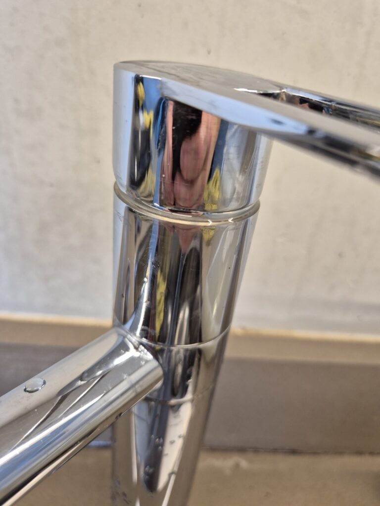Polished chrome kitchen tap after professional cleaning