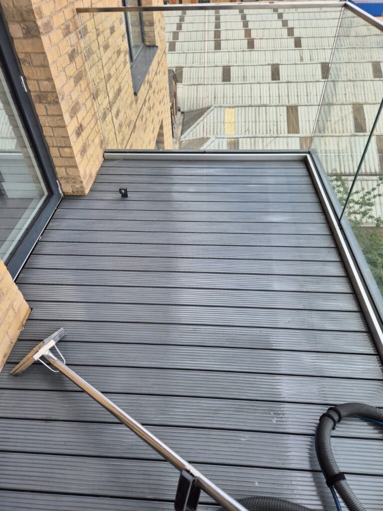 Composite decking balcony after professional cleaning, with dirt and debris removed and the surface refreshed