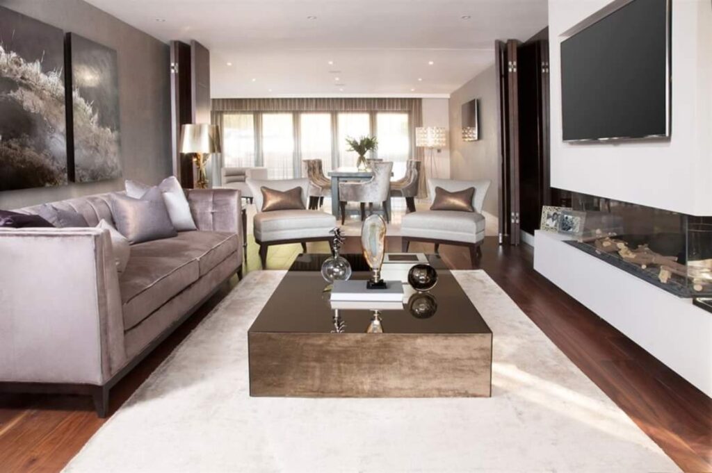 Modern luxury living room with sofa, armchairs, coffee table, fireplace and dining area