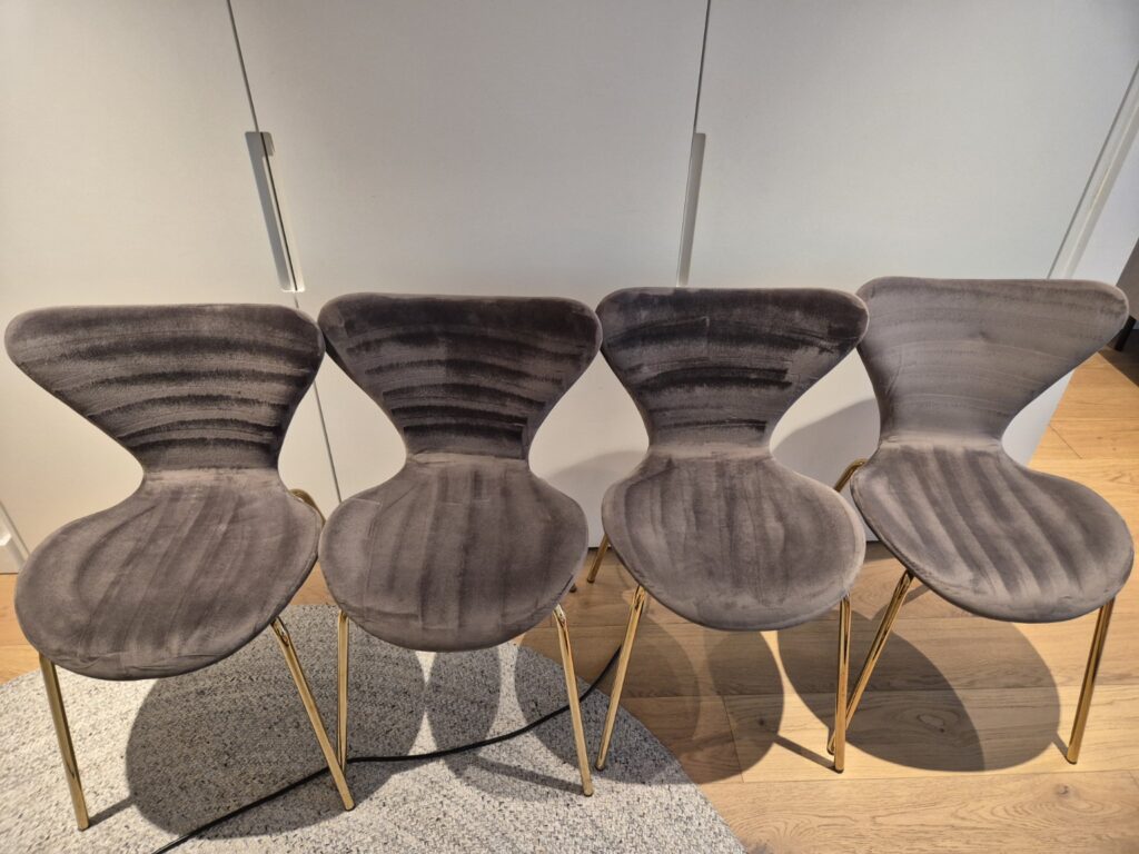Four brown upholstered dining chairs after professional upholstery cleaning, showing refreshed fabric and visible extraction lines